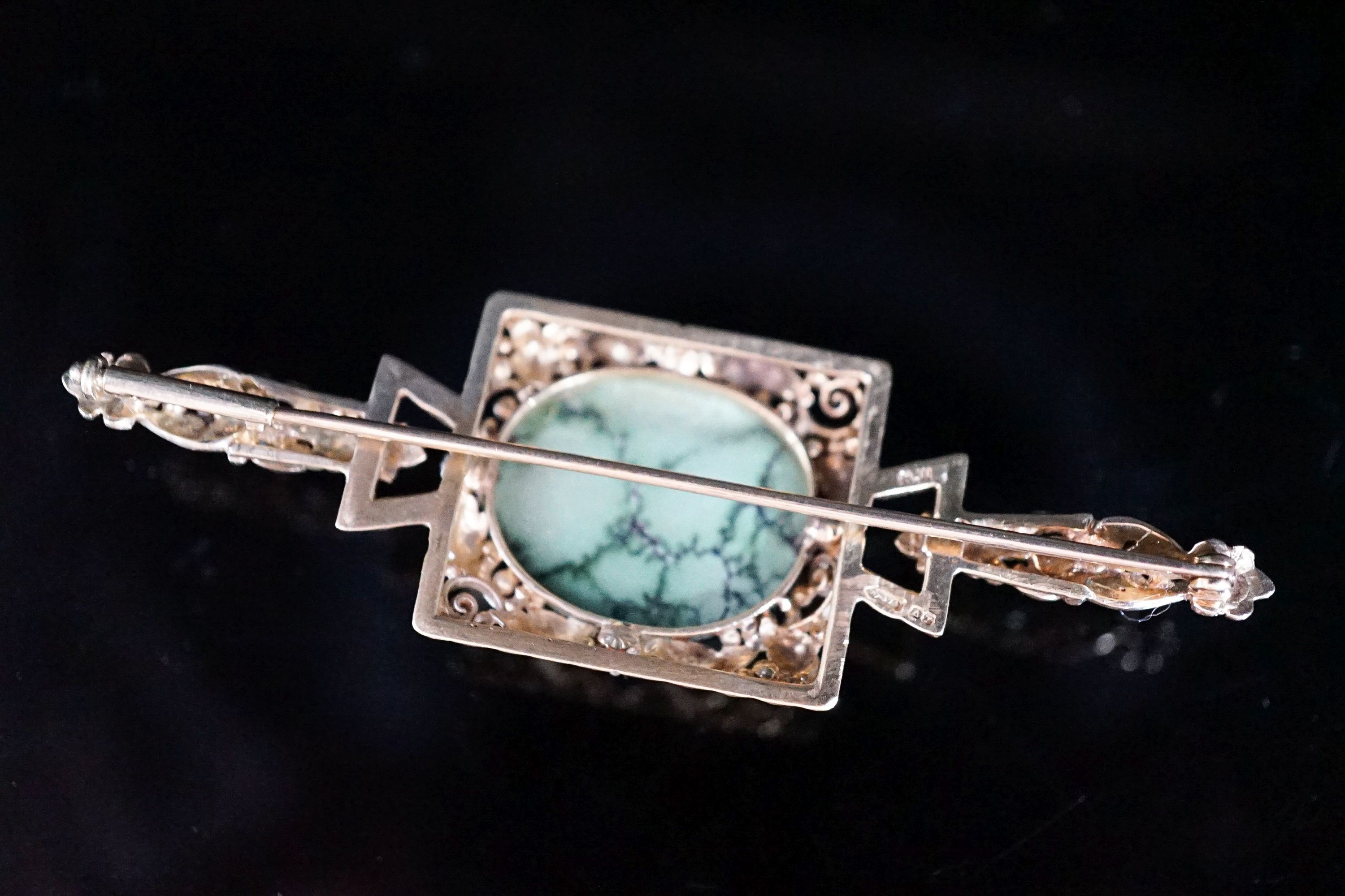 A modern 9ct gold, cabochon turquoise and four stone rose cut diamond chip set bar brooch, 67mm, 9.5 grams.